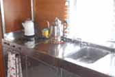 Close-up photo of stainless steel sink and kitchen counter top - 1947 Aero Flite Trailer